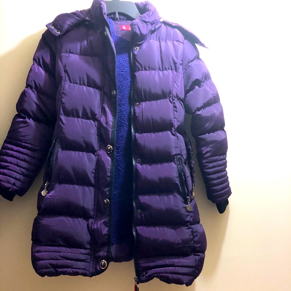 A girl’s purple coat with a hoodie